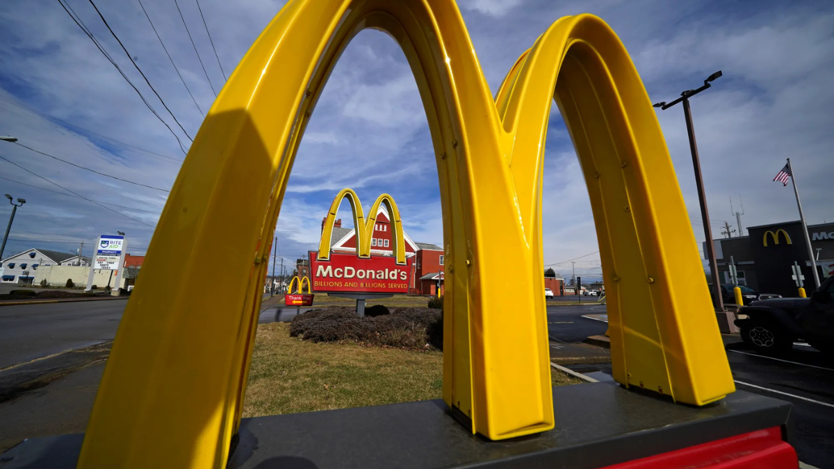 McDonald’s golden arches and restaurant signage displayed prominently beside a roadside location.
