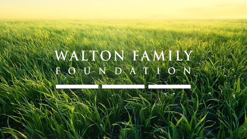 Walton Family Foundation text over green farmland field